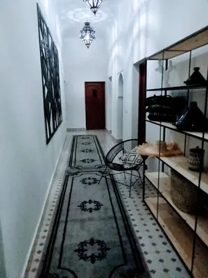 a hallway with rugs on the floor in a building at Villa privative el marjaa in Ouled el guerne