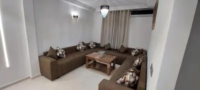 a living room with a couch and a table at Andalucia in Fès