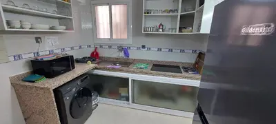 a kitchen with a sink and a stove and a refrigerator at Andalucia in Fès