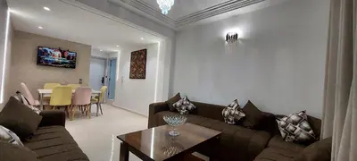 a living room with a couch and a table at Andalucia in Fès