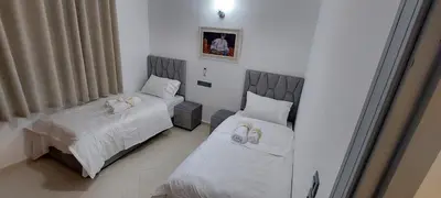 a room with two beds with towels on them at Andalucia in Fès