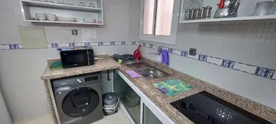 a small kitchen with a washing machine and a sink at Andalucia in Fès