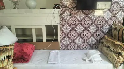 a bed with two white towels sitting on top of it at appartement bab boujloud in Fès