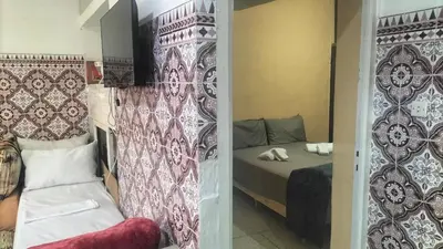 a small bedroom with a bed and a curtain at appartement bab boujloud in Fès