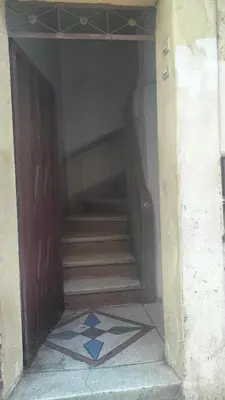 a hallway with a staircase with a door and a rug at appartement bab boujloud in Fès