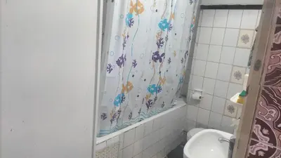 a bathroom with a shower curtain and a toilet at appartement bab boujloud in Fès
