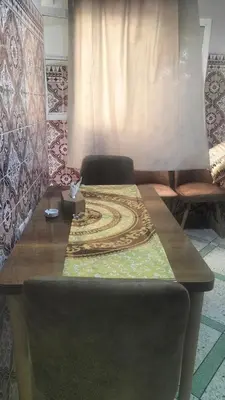 a table in a room with a couch and a rug at appartement bab boujloud in Fès