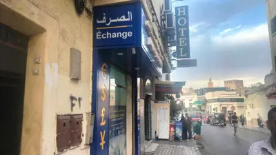 a sign for an exchange on the side of a building at appartement bab boujloud in Fès