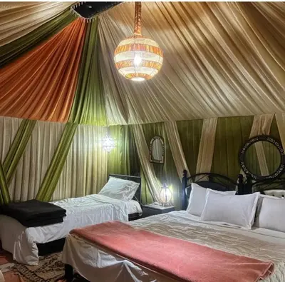 a room with two beds in a tent at Restaurant Food and Guide in Tisserdmine