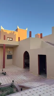 a building with an archway and a patio at Riad Azwaw in Er Rachidia
