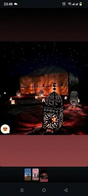 a view of a stage with a tent with lights at Merzouga camp in Merzouga