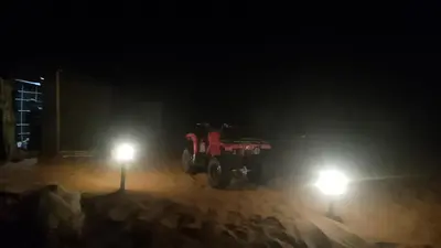 a tractor parked in the snow at night at Merzouga camp in Merzouga