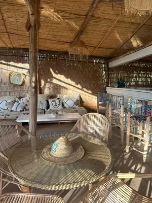a straw hat sitting on a table in a room at Villa Atika in El Bougaria