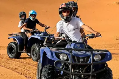 two people riding in an atv in the desert at Merzouga Twilight Camp in Merzouga