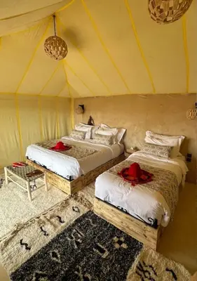 a room with two beds in a tent at Desert cmp luxury in Merzouga