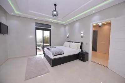a large bedroom with a bed and a window at Villa Route de Fes in Marrakesh in Douar bel Rhanodour