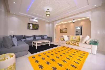 a living room with a couch and a table at Villa Route de Fes in Marrakesh in Douar bel Rhanodour