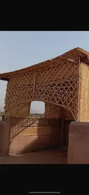 a building with a wooden roof on top at AISHAMA Healing House in Aït Ourir