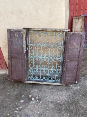an open metal gate in front of a building at AISHAMA Healing House in Aït Ourir