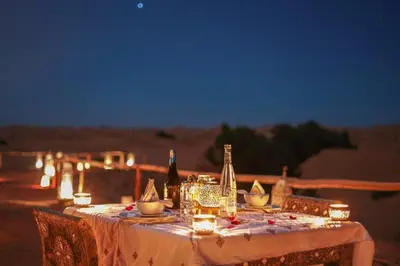 a table with bottles and candles on top of it at Princess Luxury Camp in Merzouga