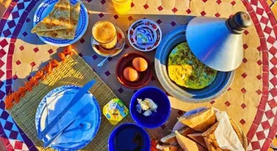 a table with many plates of food on it at Luxury tent nomads in Merzouga