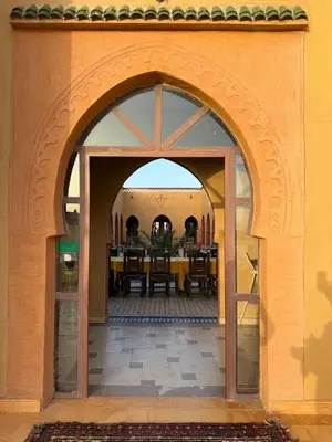 an archway leading to a dining room in a building at Hotel Berber Palace Merzouga in Merzouga