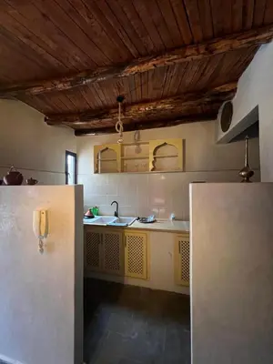a kitchen with a refrigerator in a room at Dar louqman ourika in Asguine