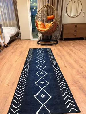 a room with a chair and a rug on the floor at Suite Bahiya 11 in Fès