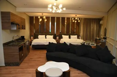 a living room with two beds and a couch at Suite Bahiya 15 in Fès