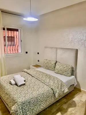 a bedroom with a bed with pillows and a window at Rare, duplex 3 chambres, proche du centre in Oulad Akkou