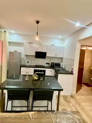 a kitchen with a table and chairs in a room at Rare, duplex 3 chambres, proche du centre in Oulad Akkou