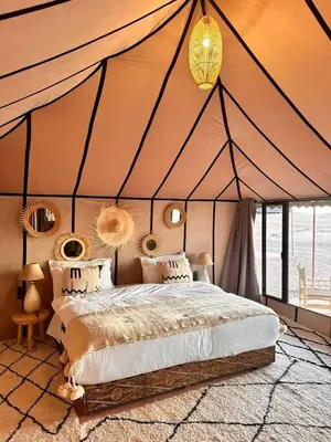 a bedroom with a bed in a tent at Starvile Luxury Camp in Merzouga