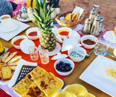 a table full of food with a pineapple on it at Starvile Luxury Camp in Merzouga