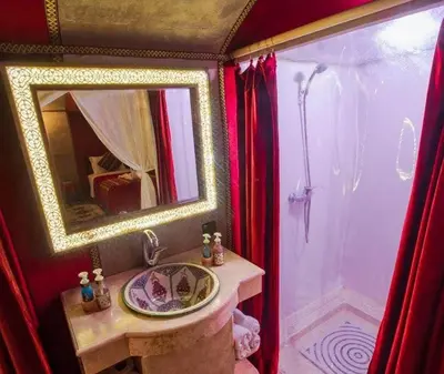 a bathroom with a sink and a mirror at Starvile Luxury Camp in Merzouga