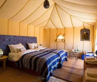 a bedroom with a large bed in a tent at Starvile Luxury Camp in Merzouga