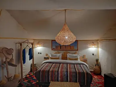 a bedroom with a large bed in a tent at Lunanir lodge Camp in Hassilabied