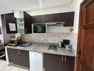 a kitchen with a sink and a counter top at Studio Appart hotel in Oulad Akkou