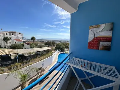 a balcony with a view of a pool at Studio Appart hotel in Oulad Akkou