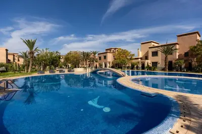 a large swimming pool with blue water at Malaya Majestic in Srarhna