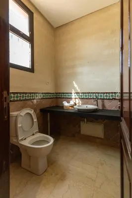 a bathroom with a toilet and a sink at Malaya Majestic in Srarhna