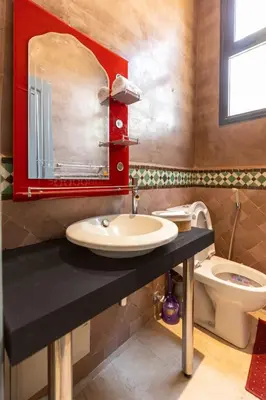 a bathroom with a sink and a toilet at Malaya Majestic in Srarhna