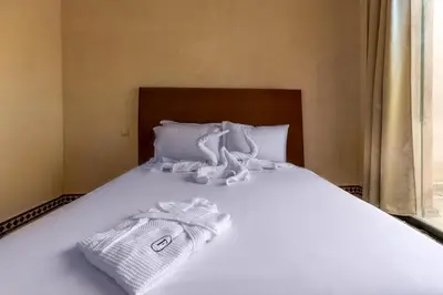 a bed with two towels sitting on top of it at Malaya Majestic in Srarhna