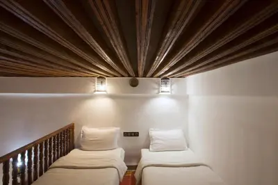 two beds in a room with a ceiling at Riad Ruh Fes in Fès