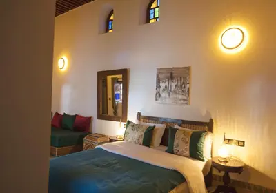 a bedroom with a bed and a couch at Riad Ruh Fes in Fès