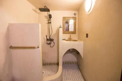 a small bathroom with a sink and a mirror at Riad Ruh Fes in Fès