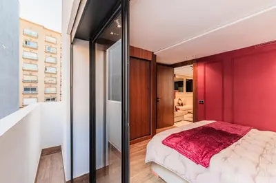 a bedroom with a red accent wall and a bed at Luxury Suite des Princesses in Oulad Akkou