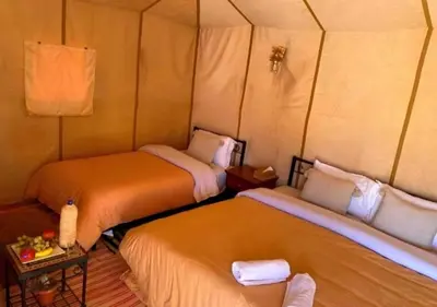 a room with two beds in a room at Camp Lovers Desert in Merzouga