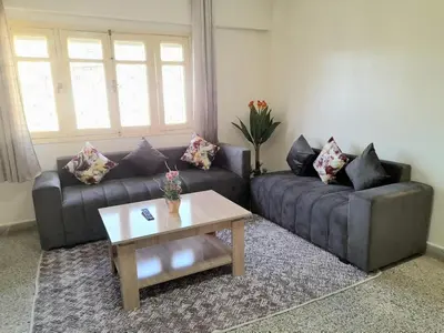 a living room with two couches and a coffee table at City Center Apartment Fez in Fès