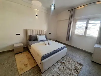 a bedroom with a bed and a window at City Center Apartment Fez in Fès