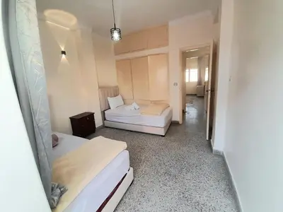 a room with two beds and a hallway at City Center Apartment Fez in Fès